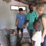 Project Managers Corey Spies (left) and Brianna Parsons (right) meet with a Gambian smallholder farmer to learn about feed sourcing in The Gambia